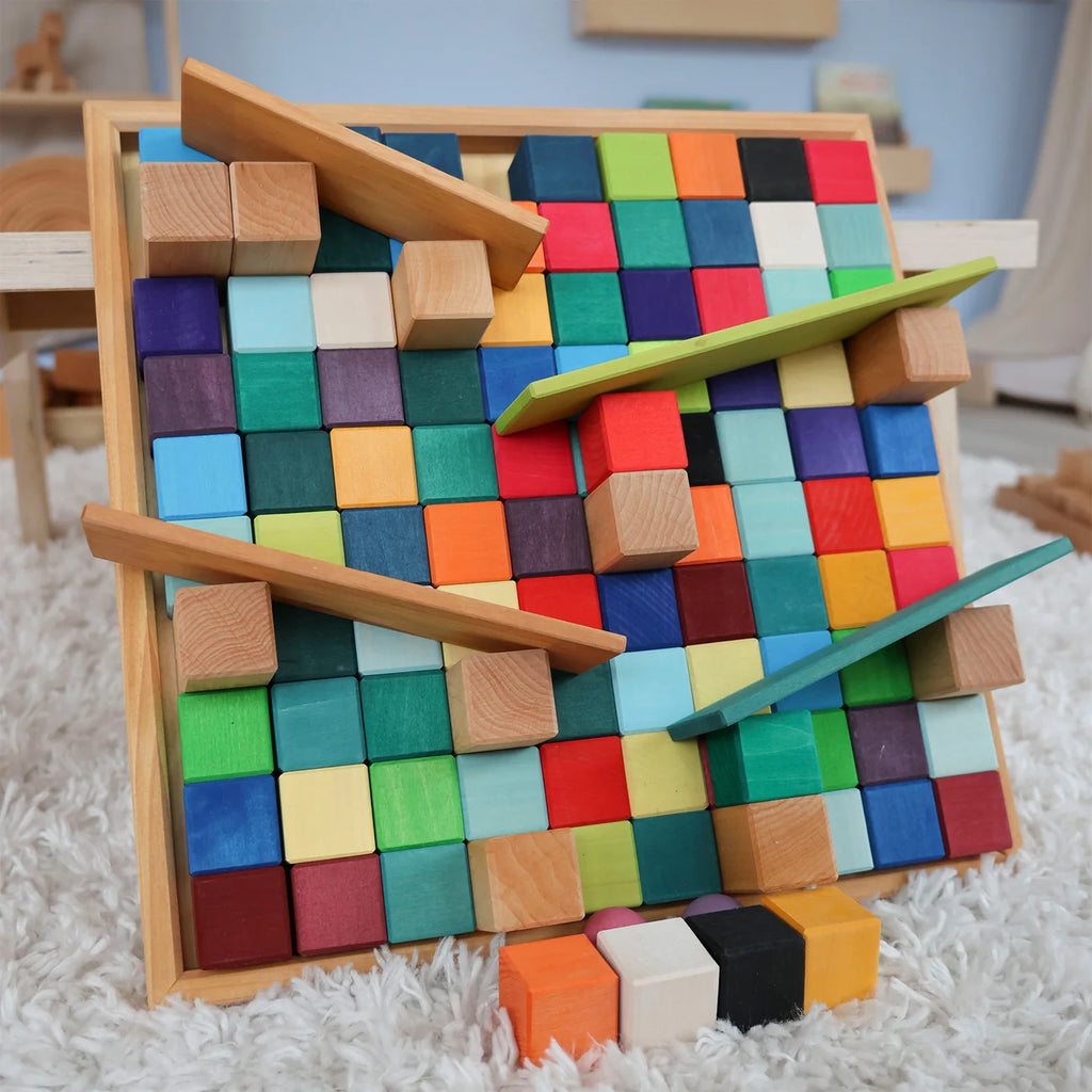Colorful wooden block puzzle on a white carpet