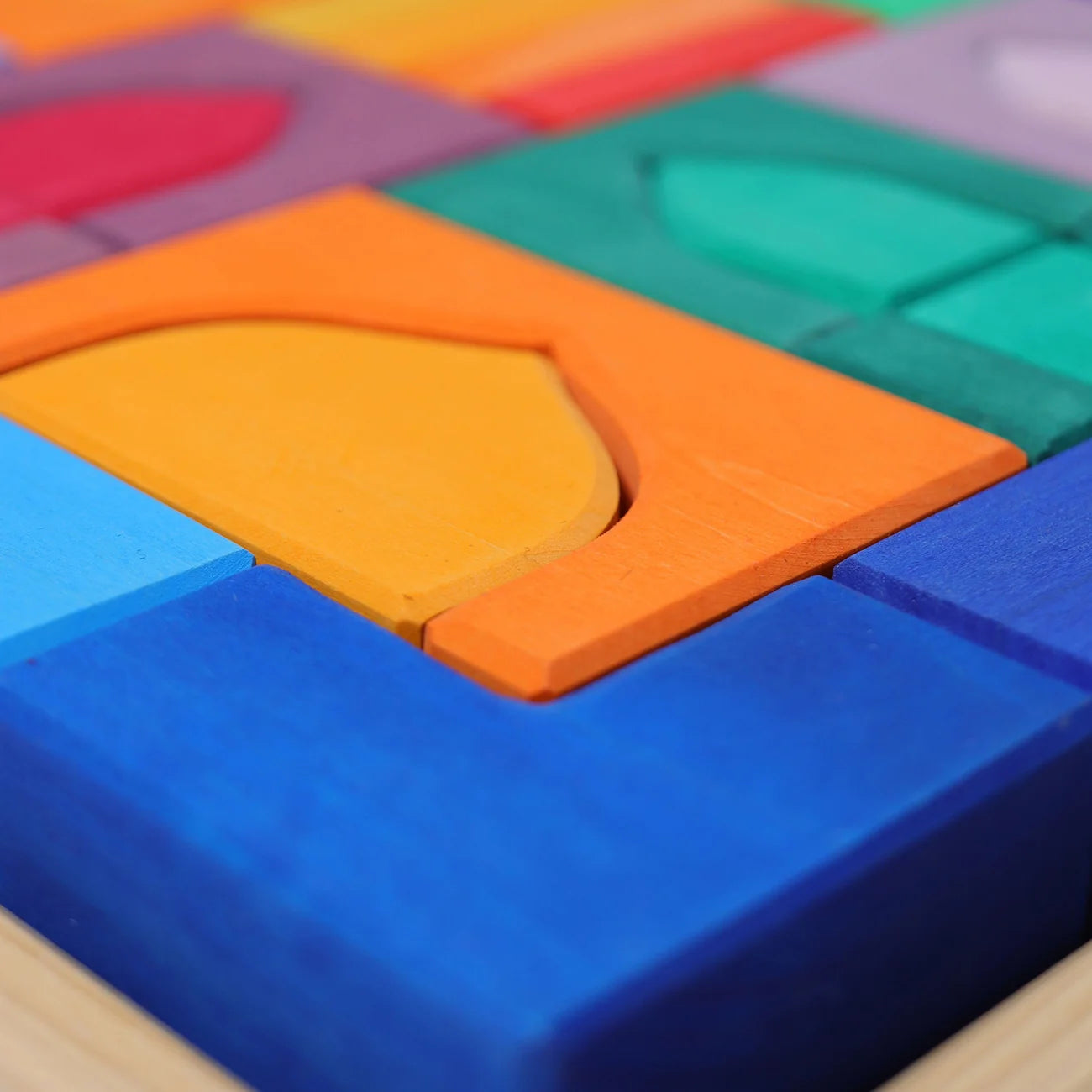 Close-up of colorful wooden puzzle blocks on a wooden surface