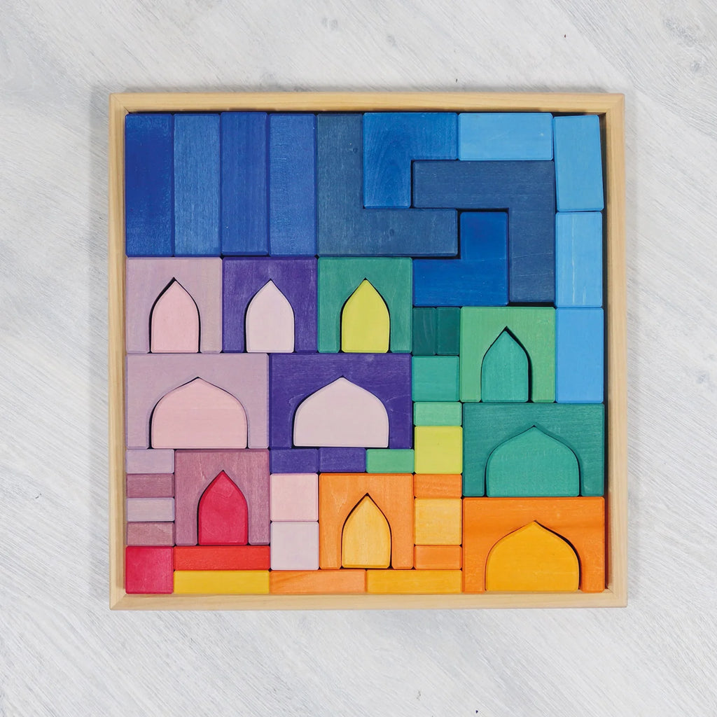 Colorful wooden block puzzle with geometric shapes on a light gray background