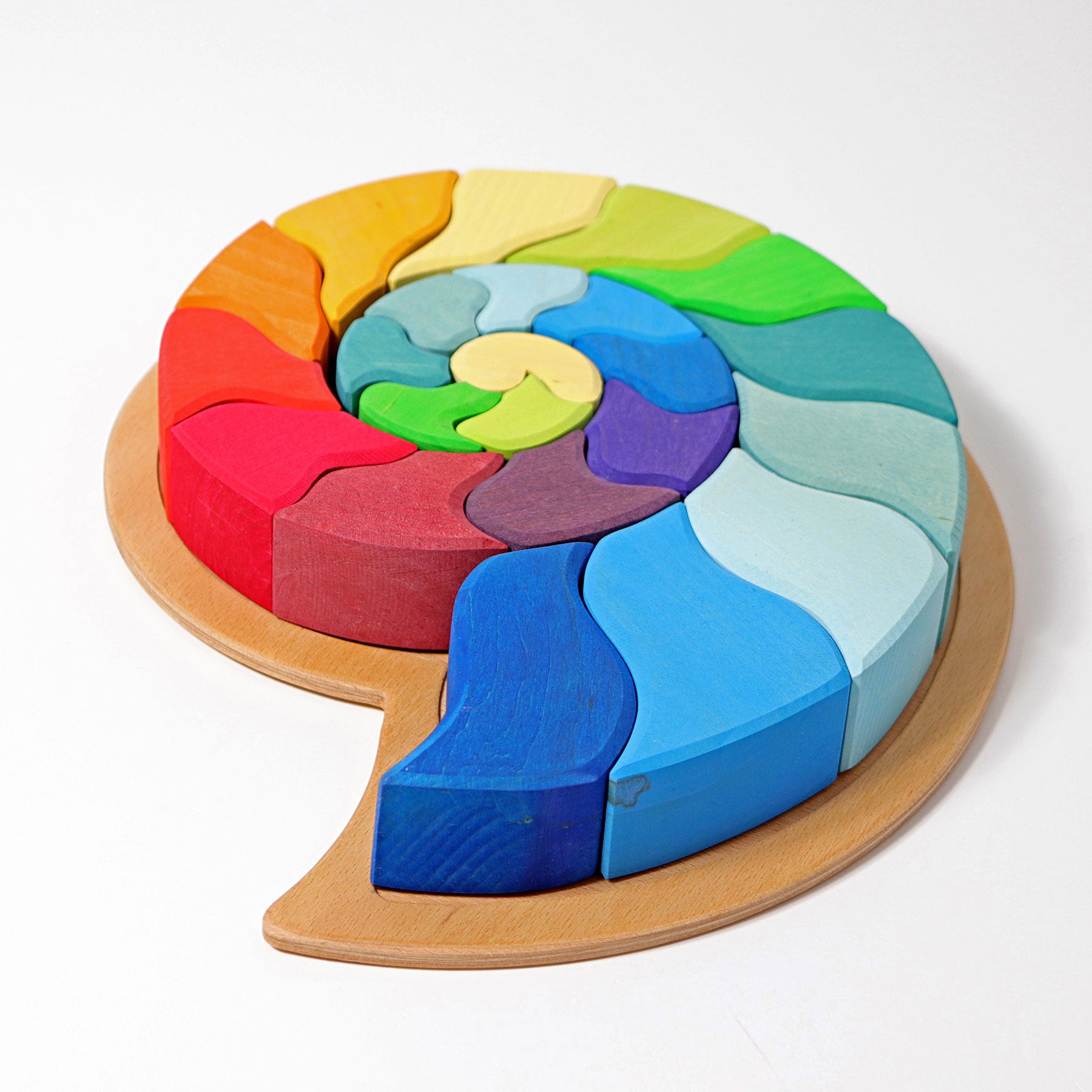 Colorful wooden puzzle shaped like a brain on a white background