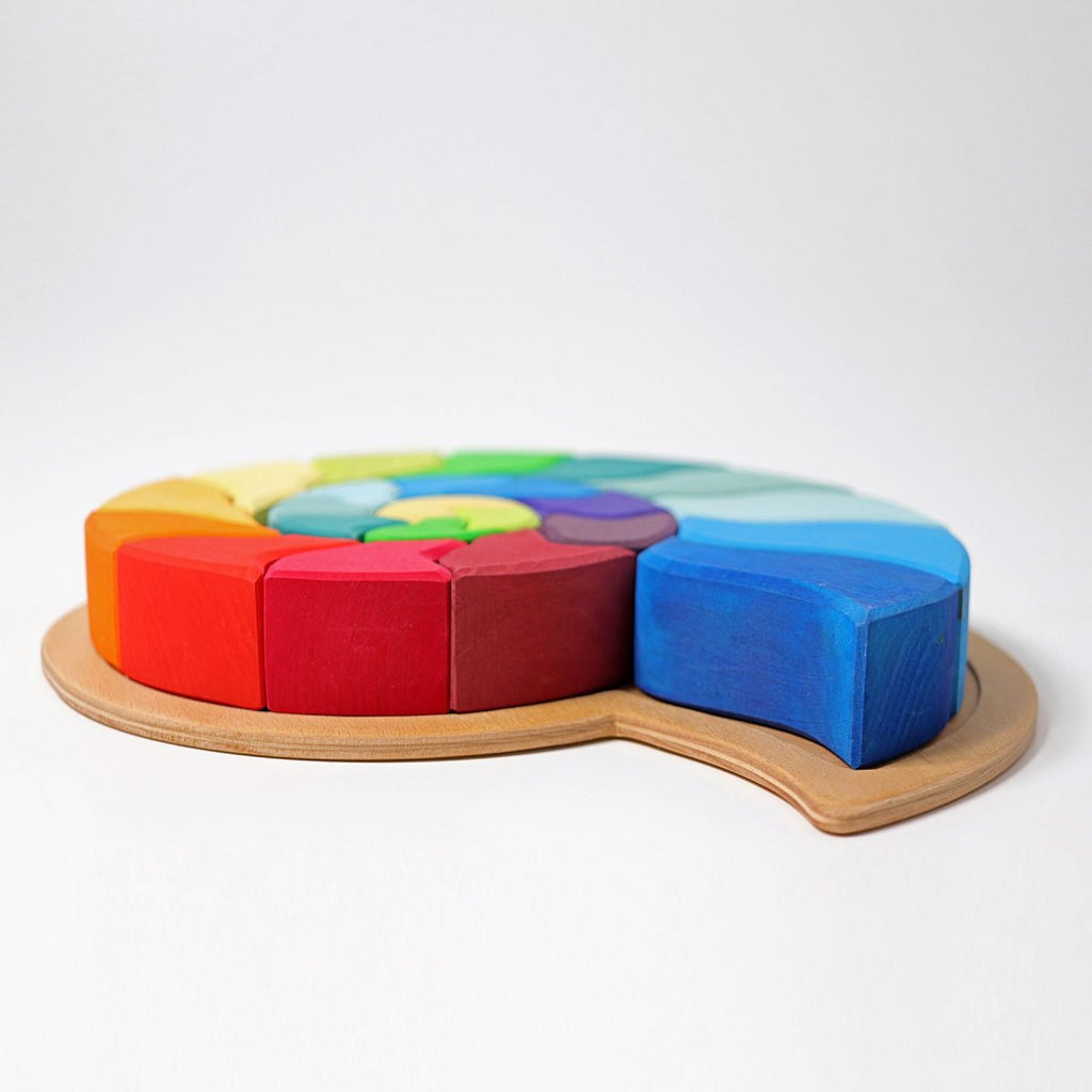 Colorful wooden toy with geometric shapes on a white background