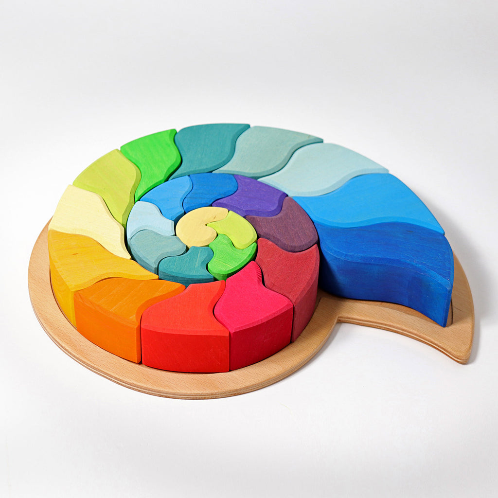 Colorful wooden puzzle with a spiral design on a white background