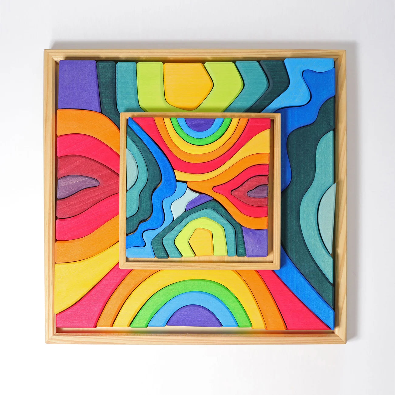 Colorful abstract art piece in a wooden frame on a white background