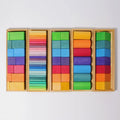 Set of colorful wooden blocks in a wooden box on a white background