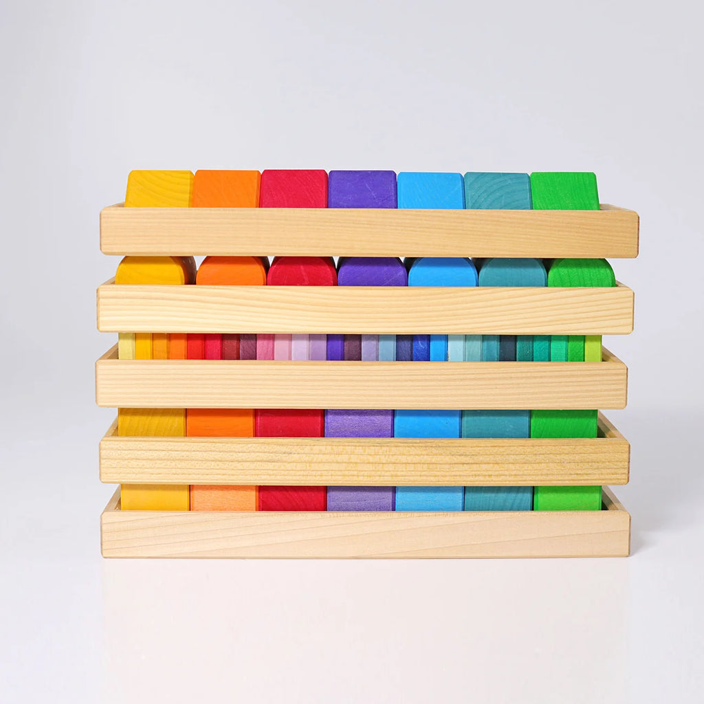 Stack of colorful wooden blocks on a light gray background