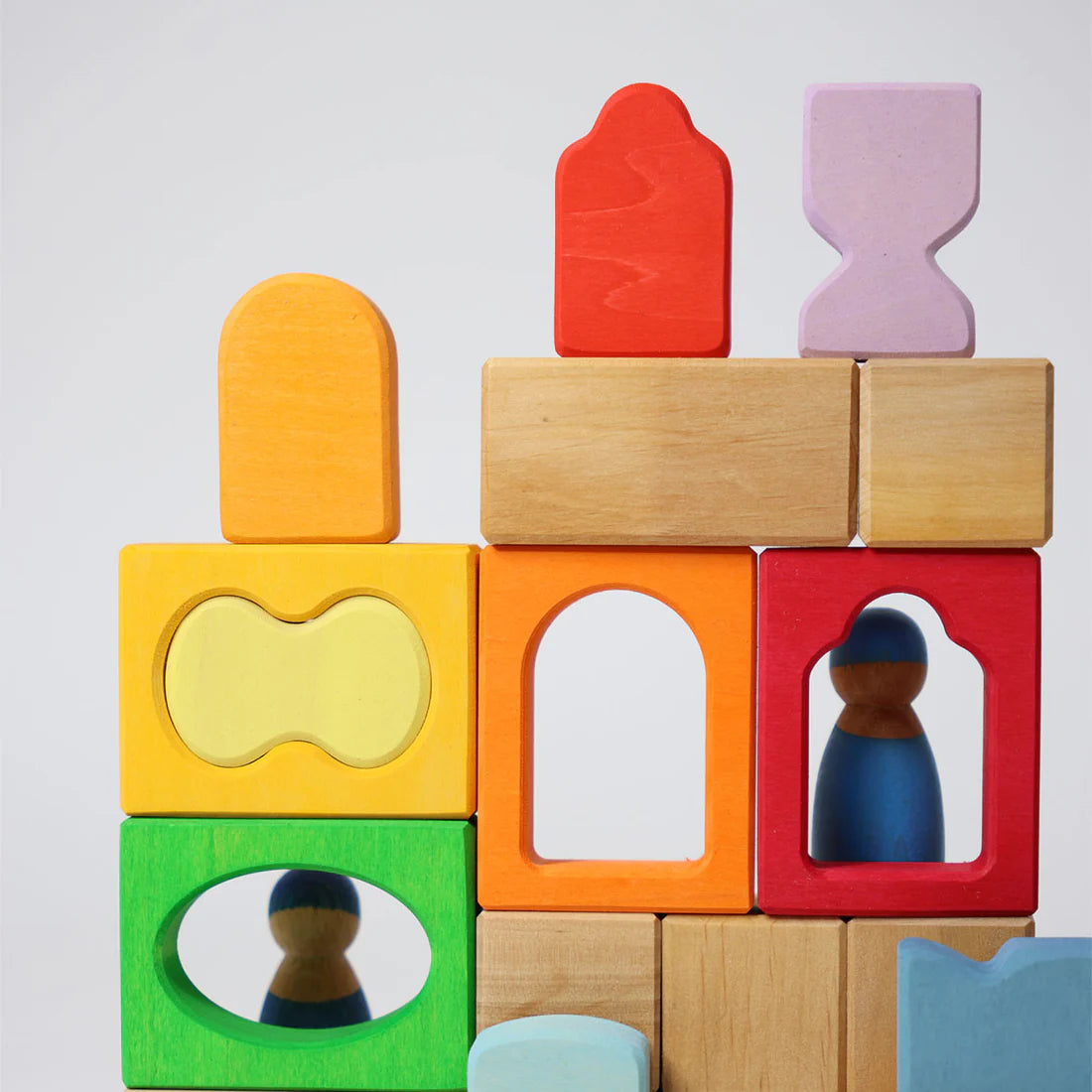 Colorful wooden blocks with embedded figures on a light gray background