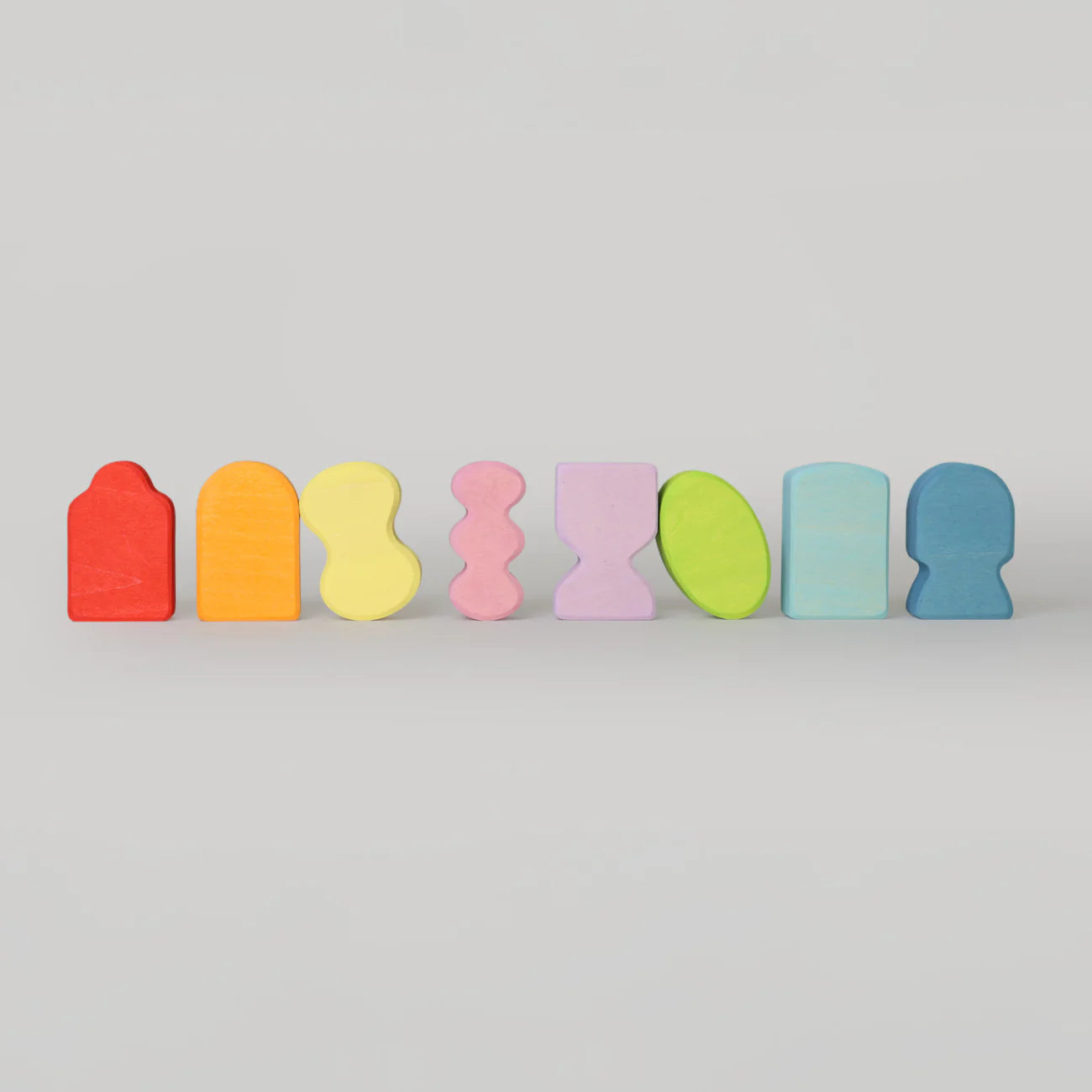 Set of colorful wooden blocks on a light gray background