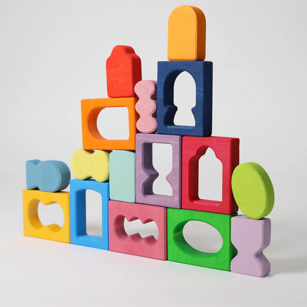 Colorful wooden blocks stacked on a light gray background