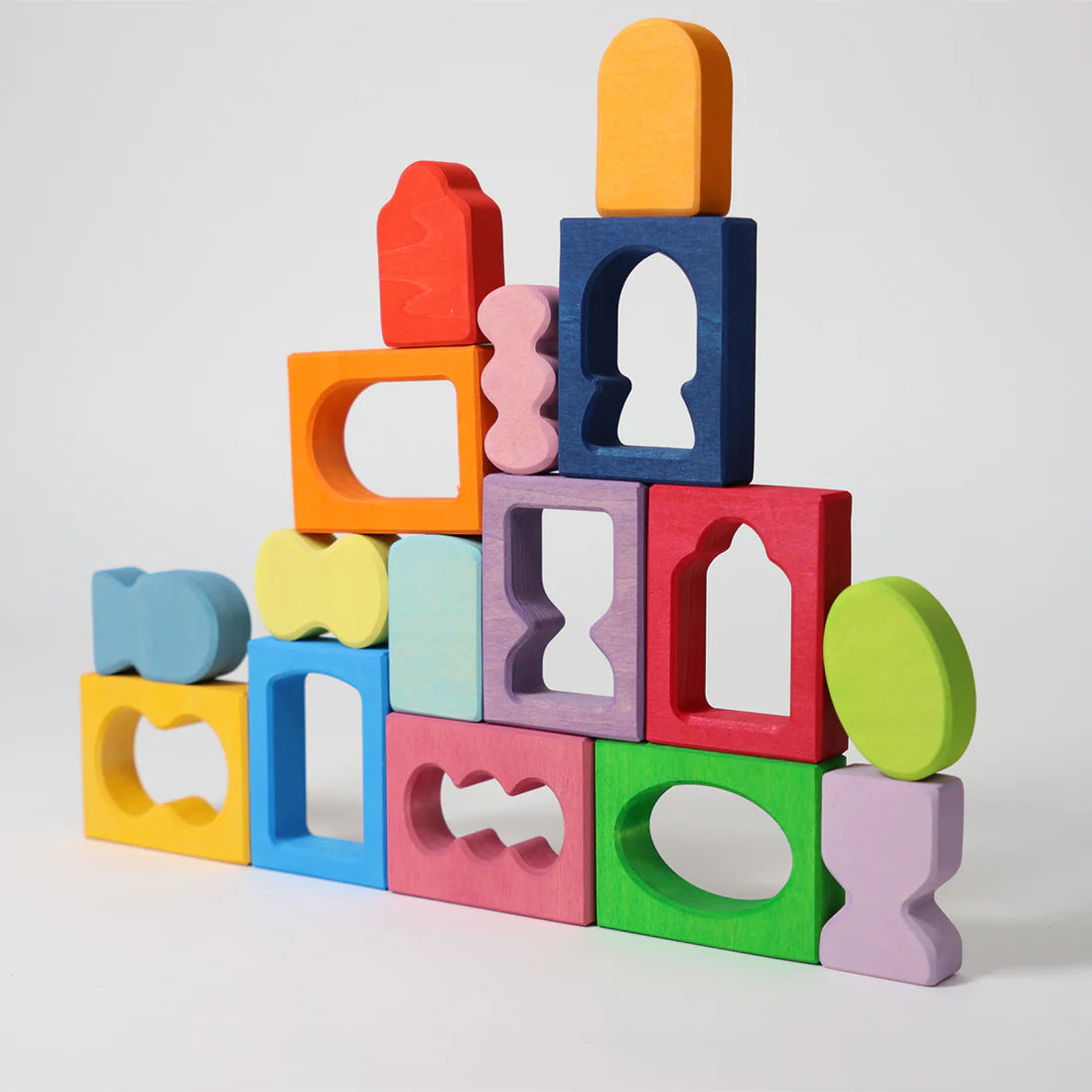 Colorful wooden blocks stacked on a light gray background