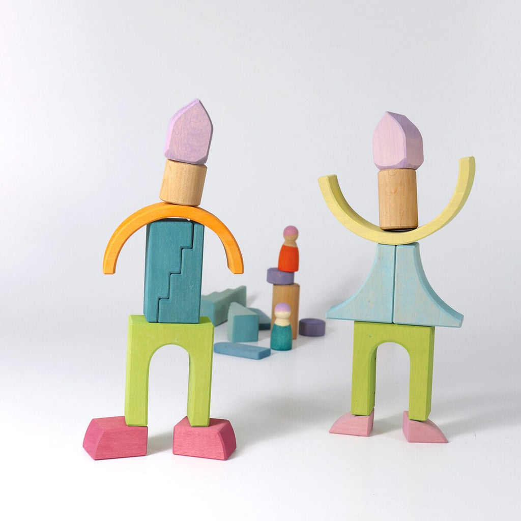 Colorful wooden block figures on a white background