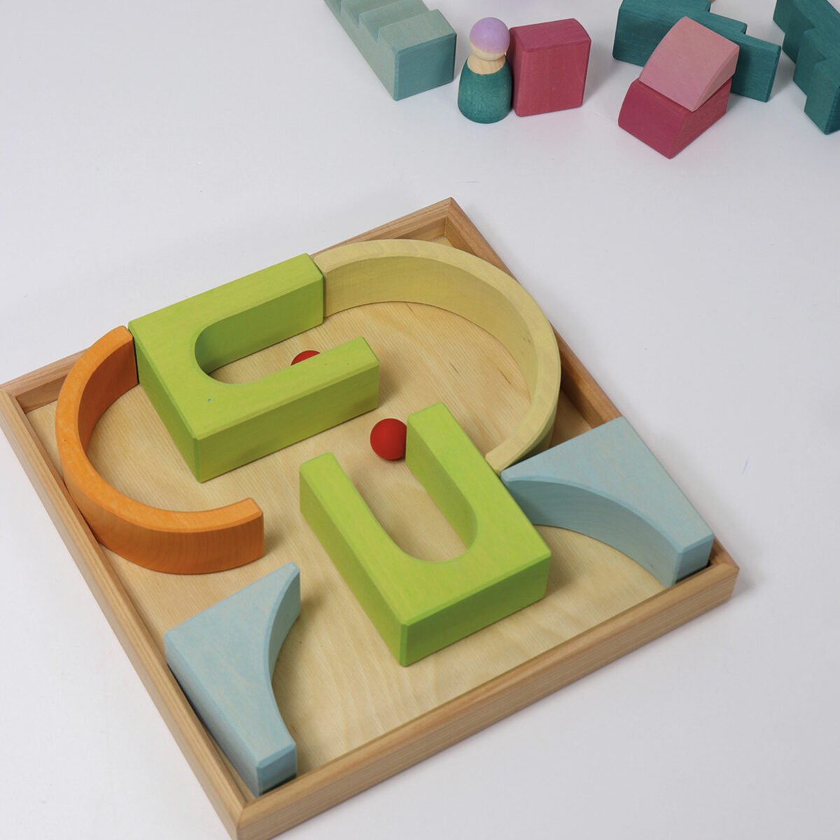 Colorful wooden geometric shape sorting toy on a white background