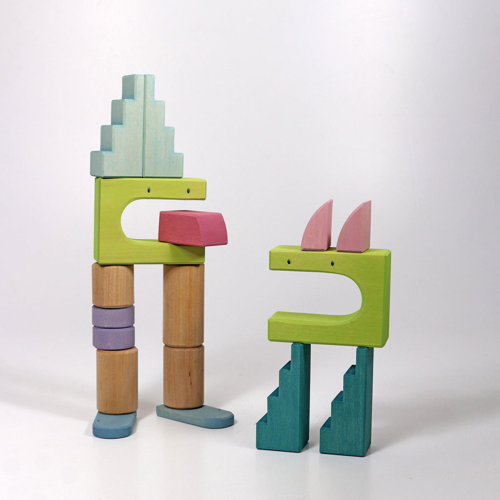Colorful wooden toy figures on a white background
