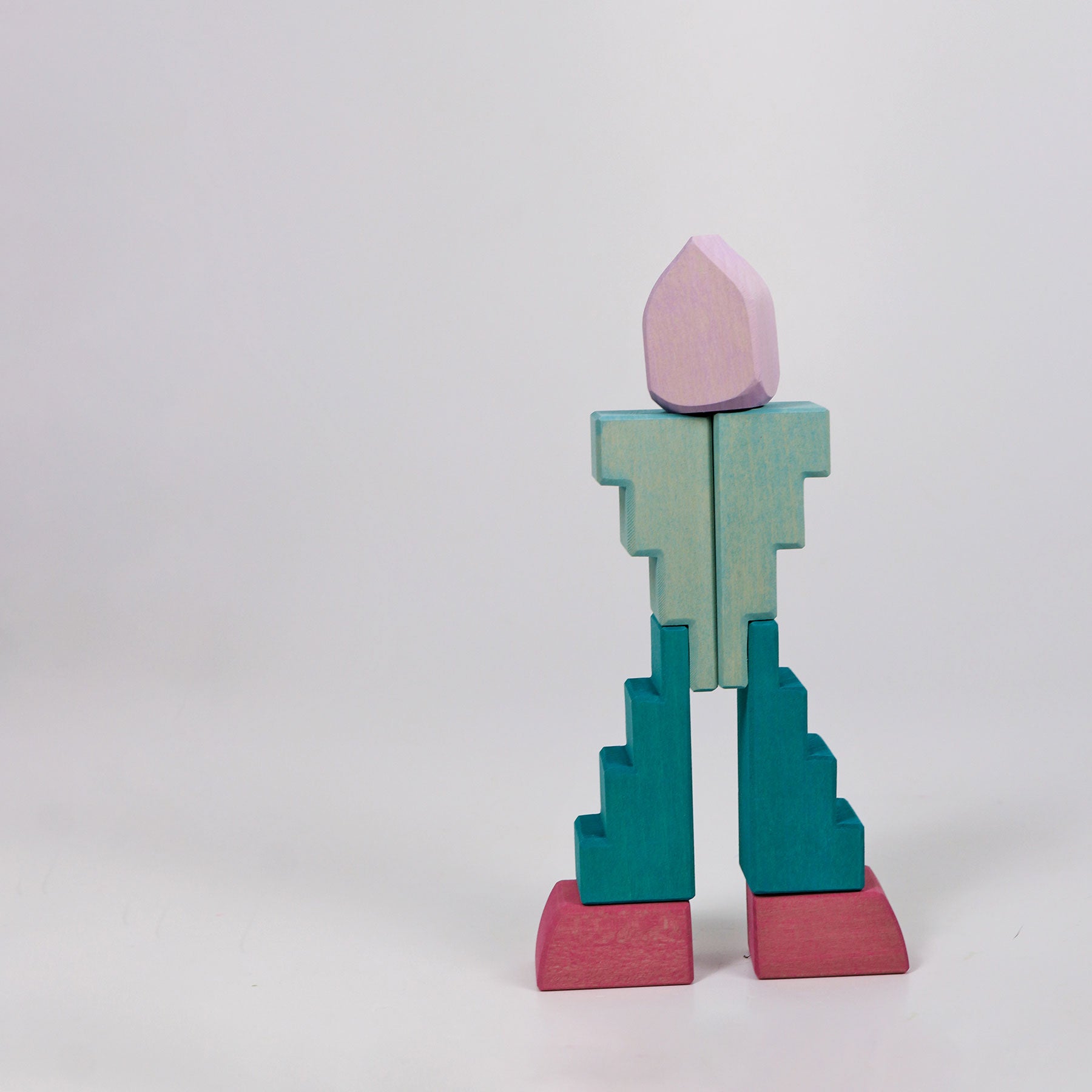 Colorful geometric block sculpture on a white background
