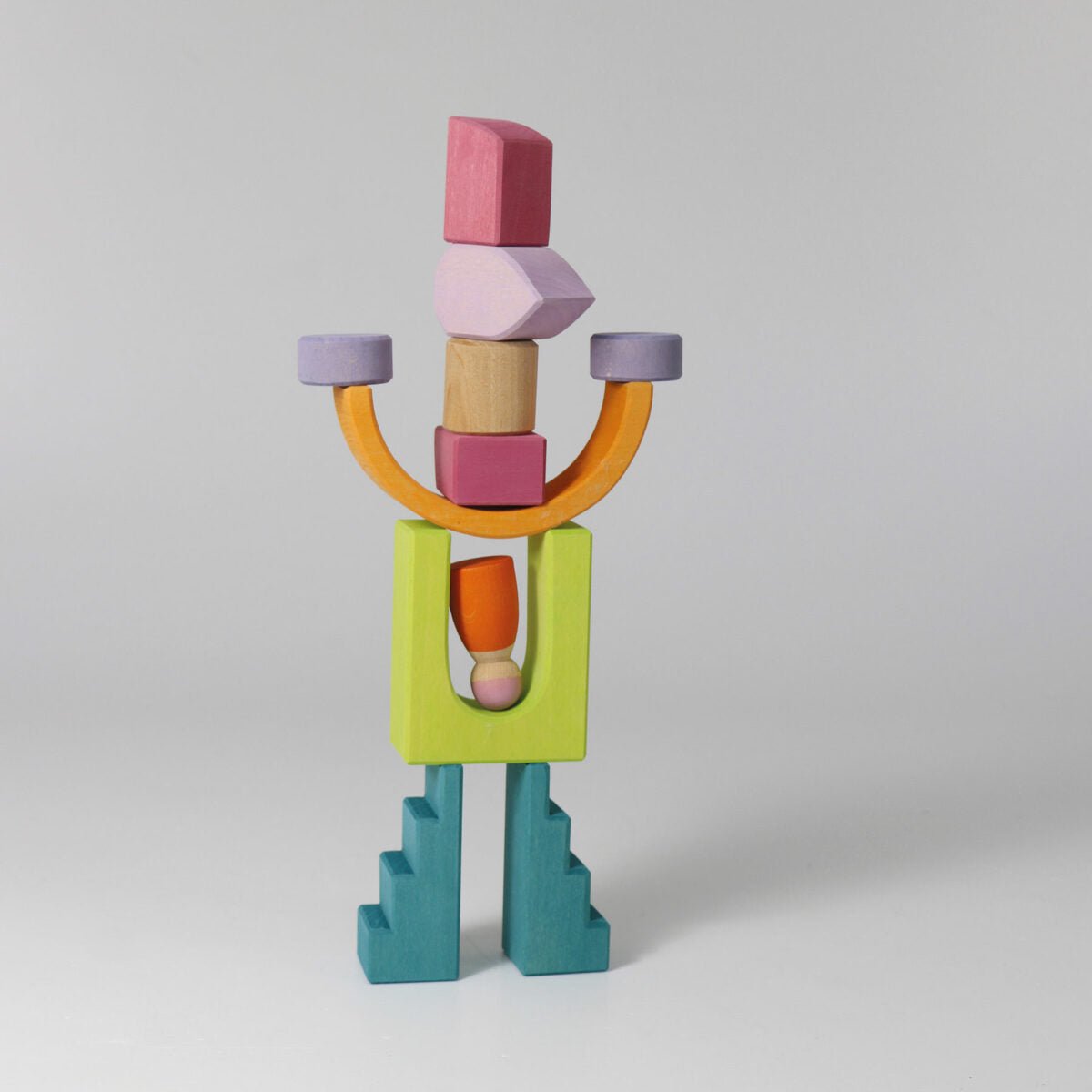 Colorful wooden block sculpture on a light gray background