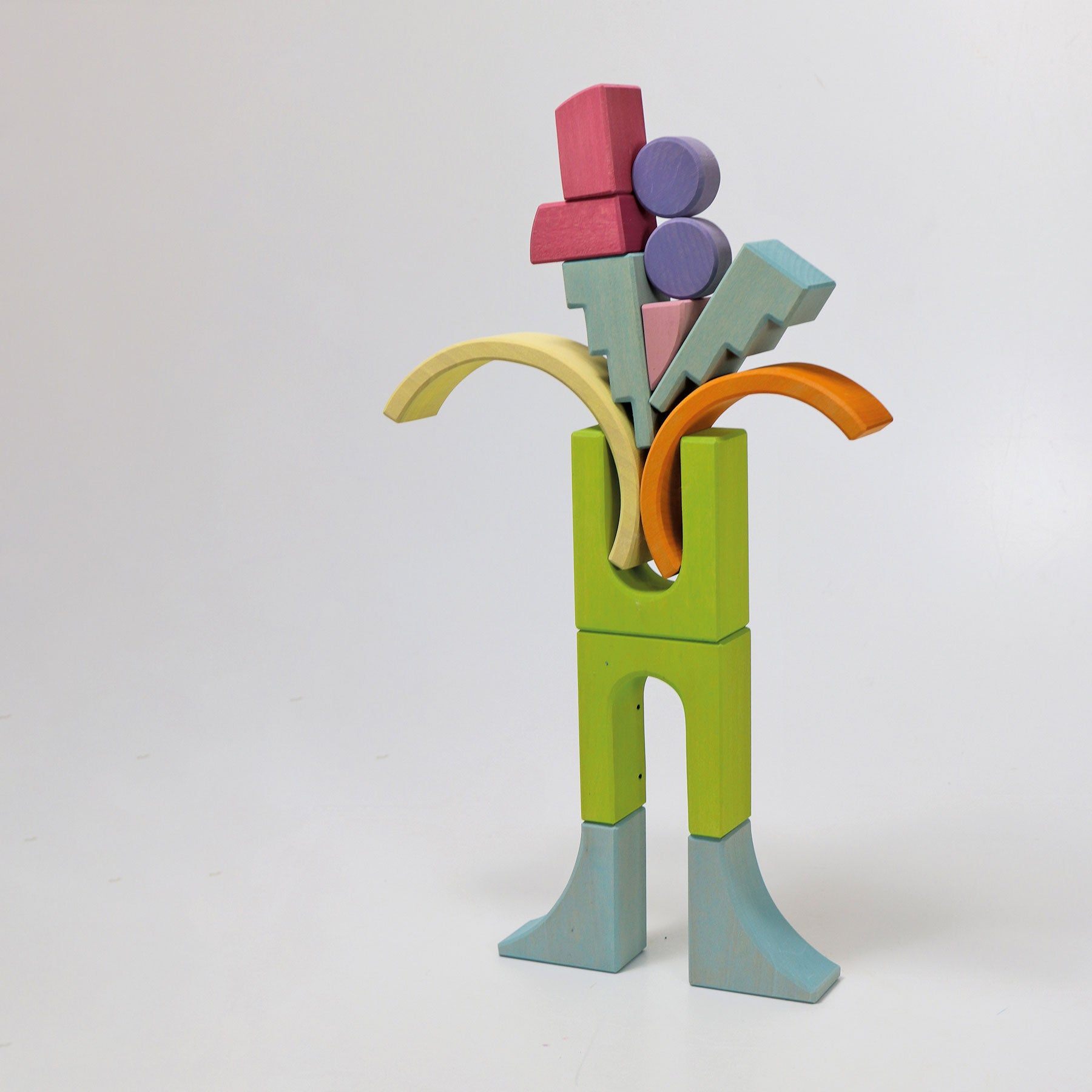 Colorful wooden toy figure with geometric blocks on a white background