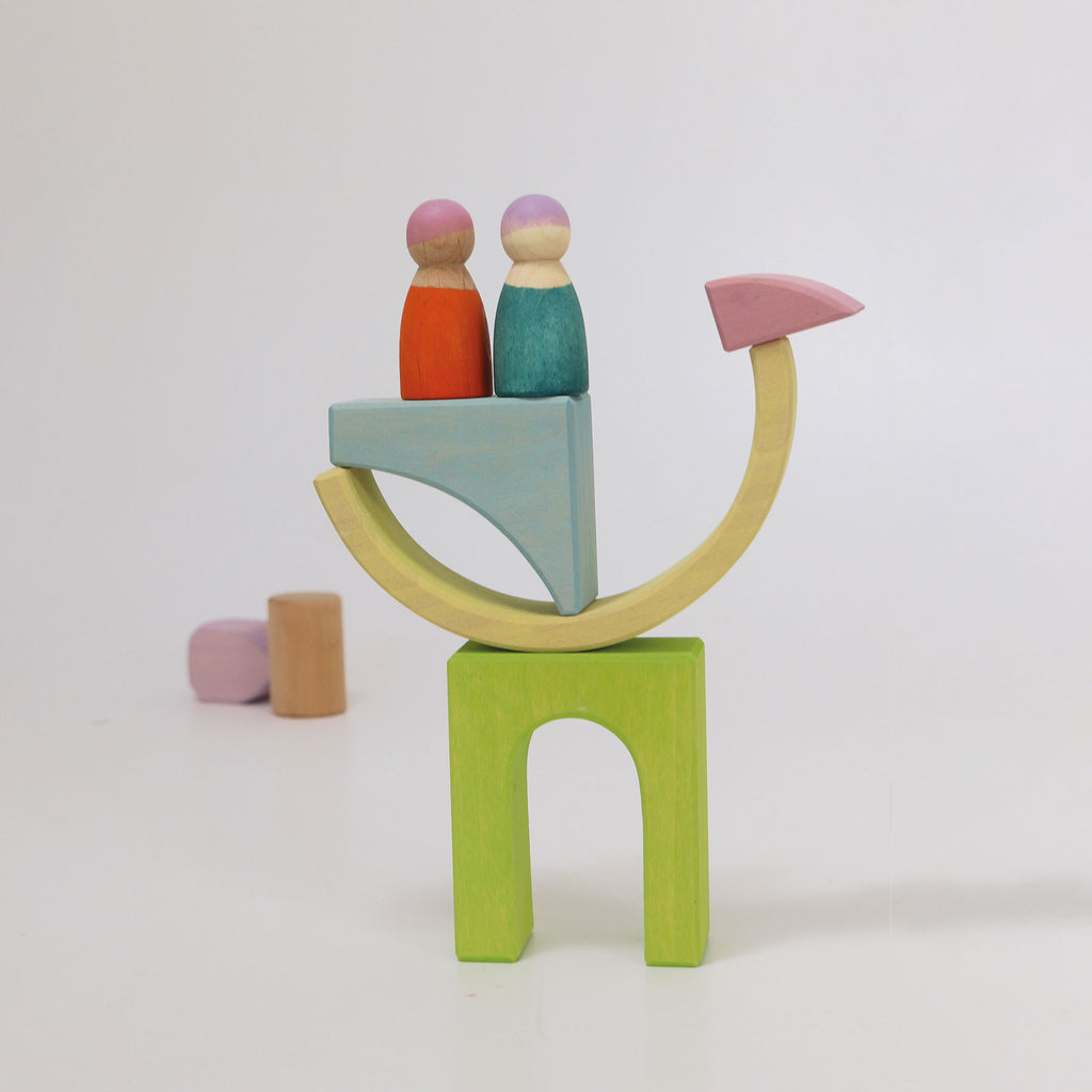 Colorful wooden toy set with two peg people on a white background