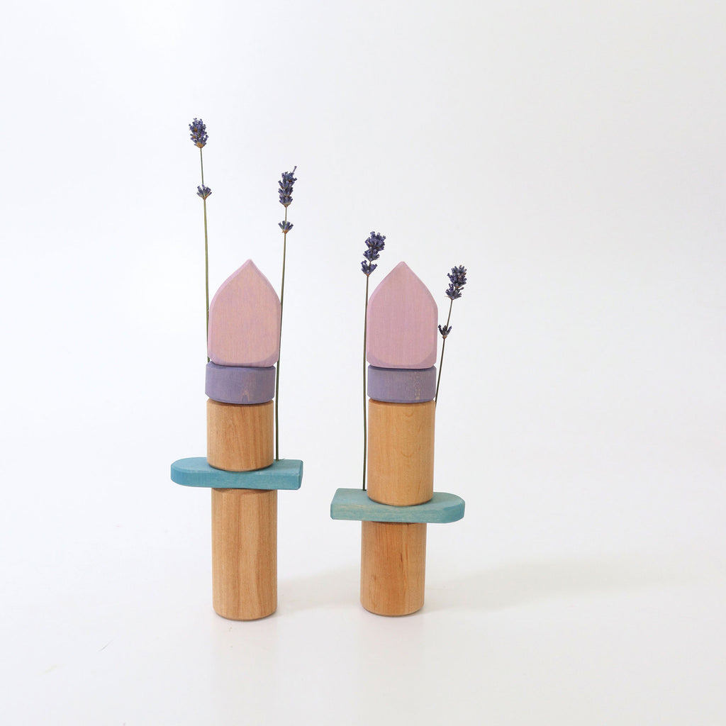 Two wooden towers and dried lavender on a white background
