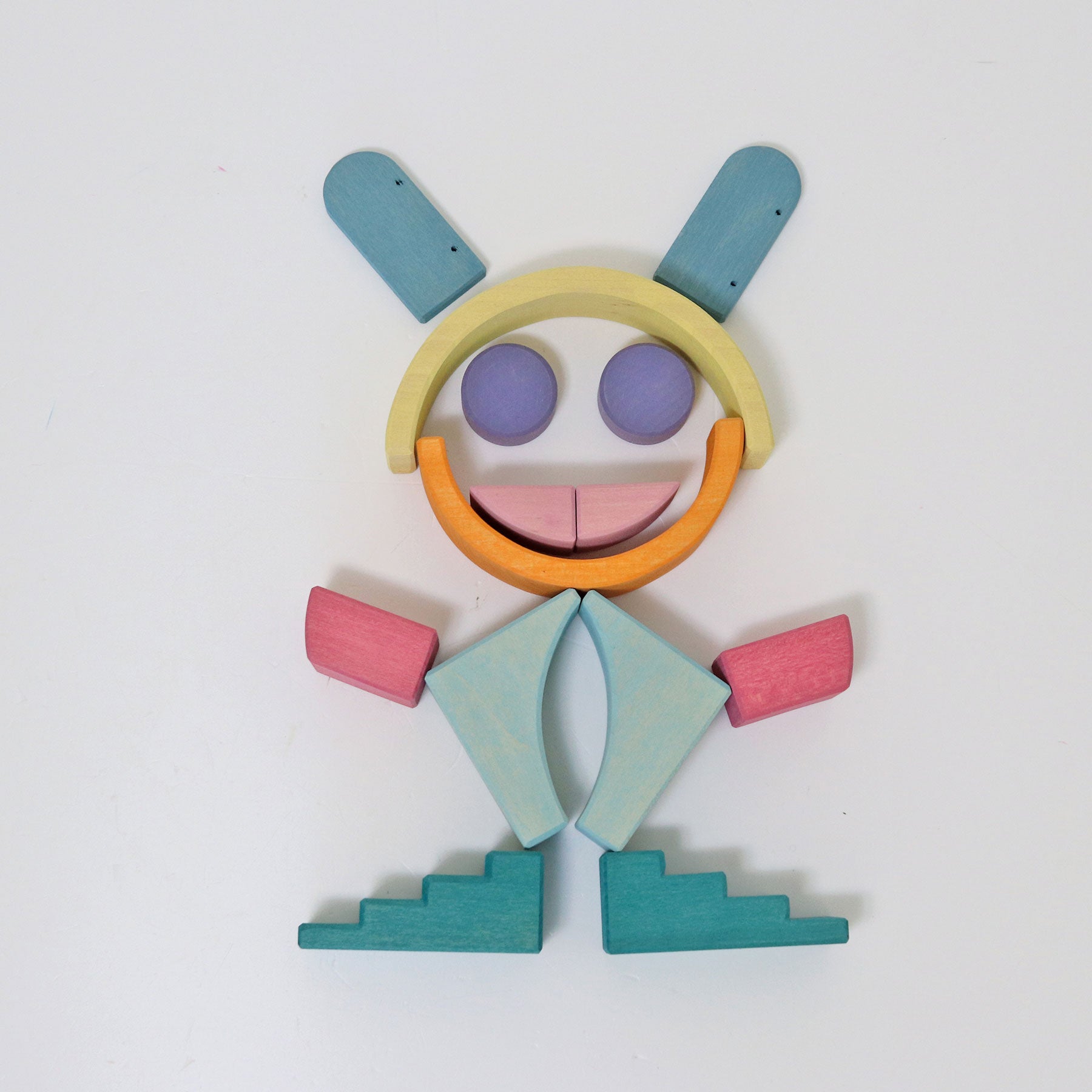 Colorful wooden toy figure on a white background