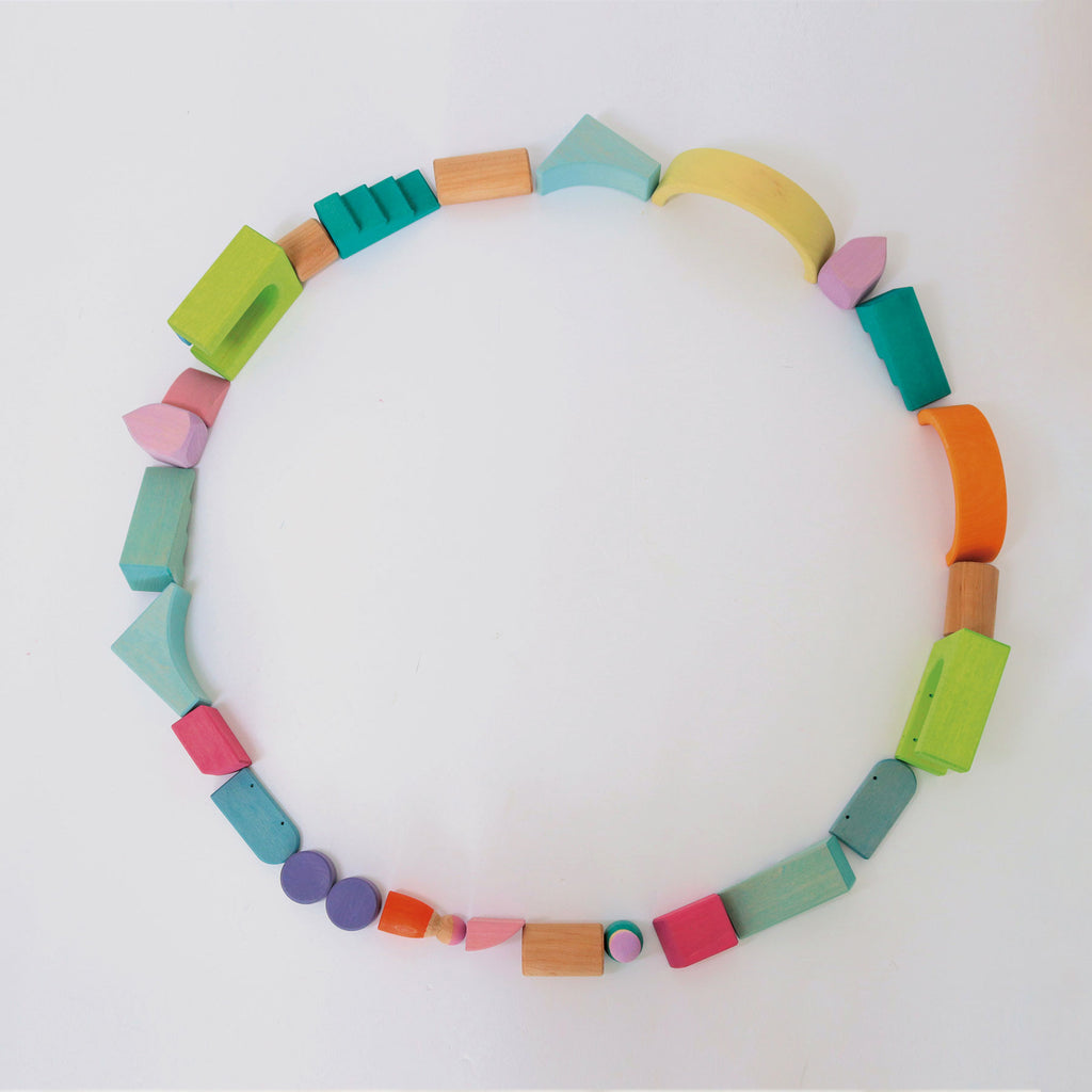 Colorful necklace made of various shaped beads on a white background