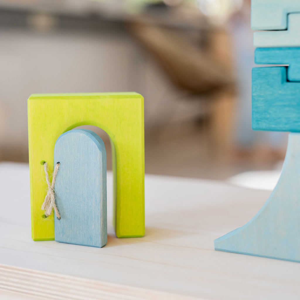 Colorful wooden toy with a small door on a blurred background