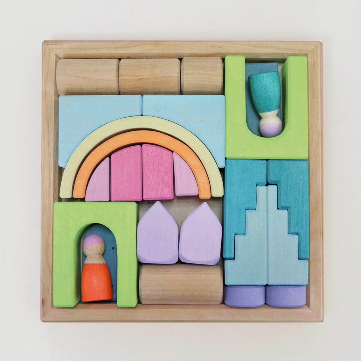 Colorful wooden building blocks with a rainbow and people figures on a light background