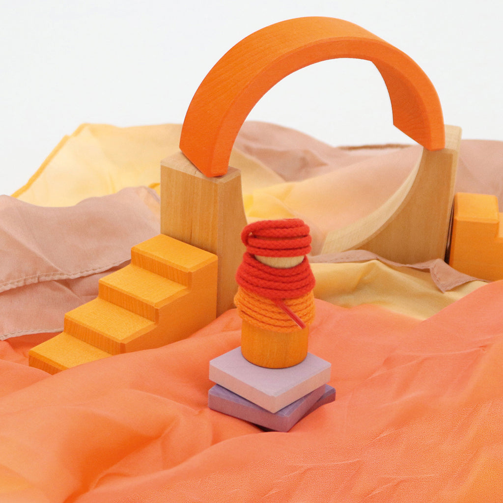 Colorful wooden blocks on a soft fabric background