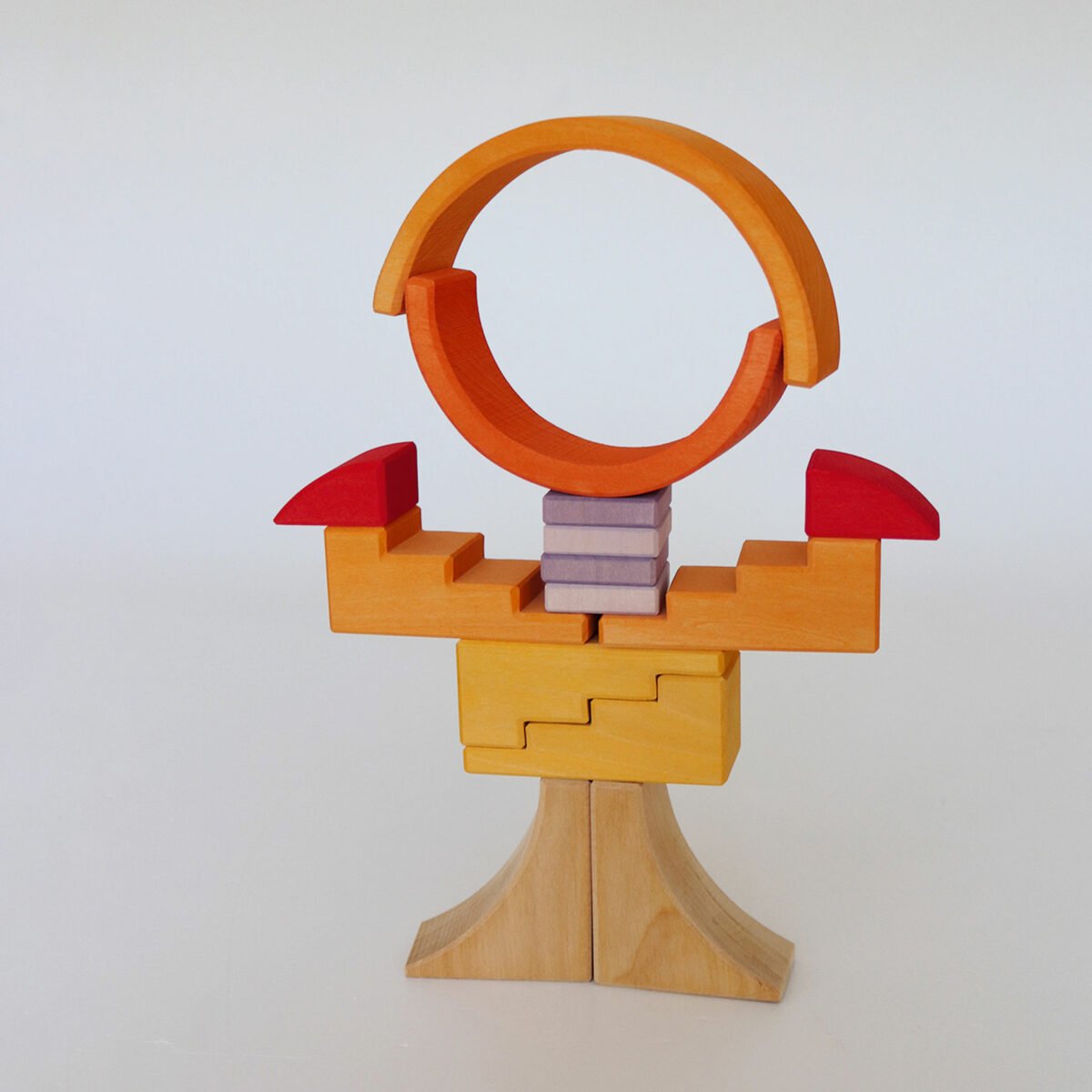 Wooden toy structure with orange loops, red triangles, and a beige base on a white background