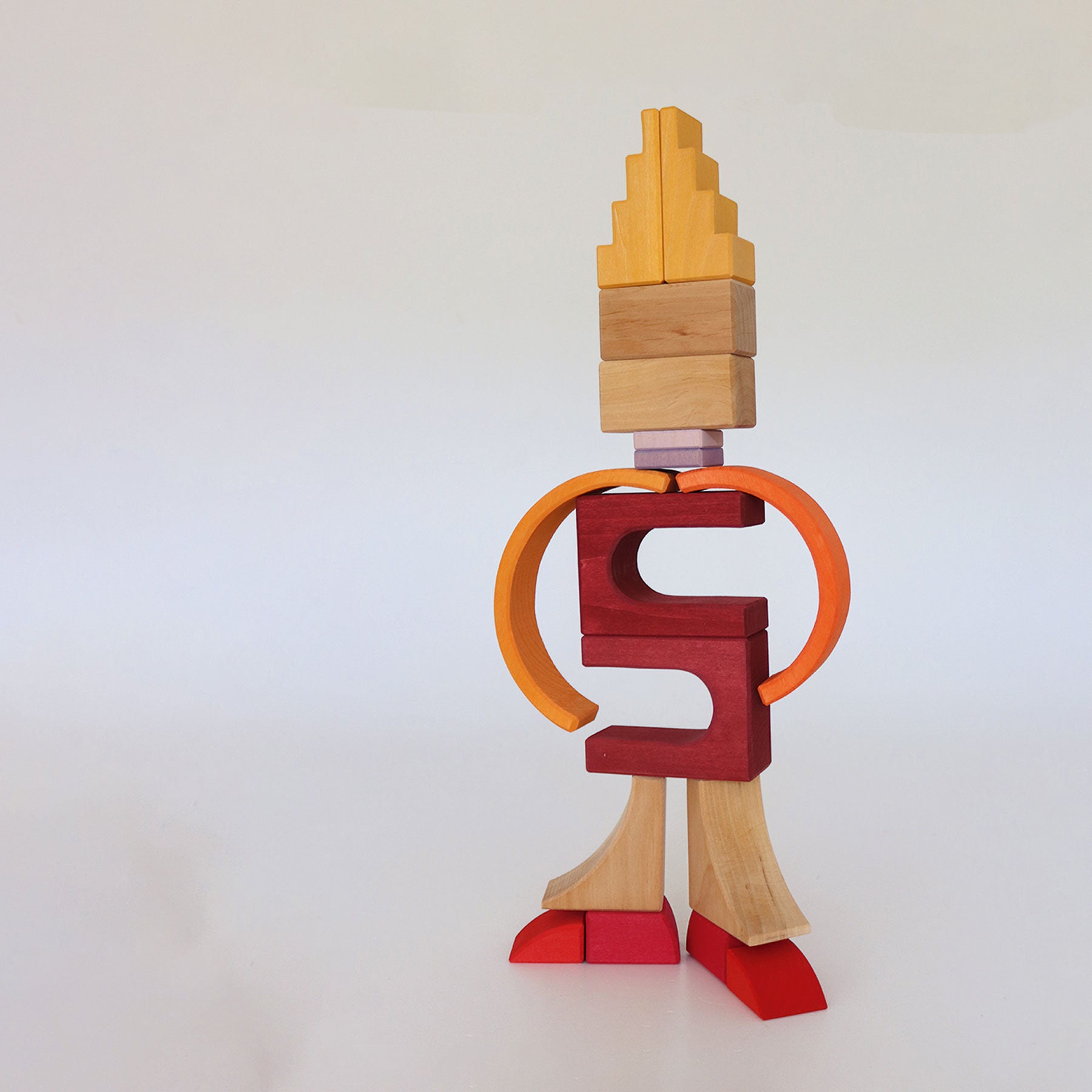 Wooden toy figure with a red torso and orange arms on a white background