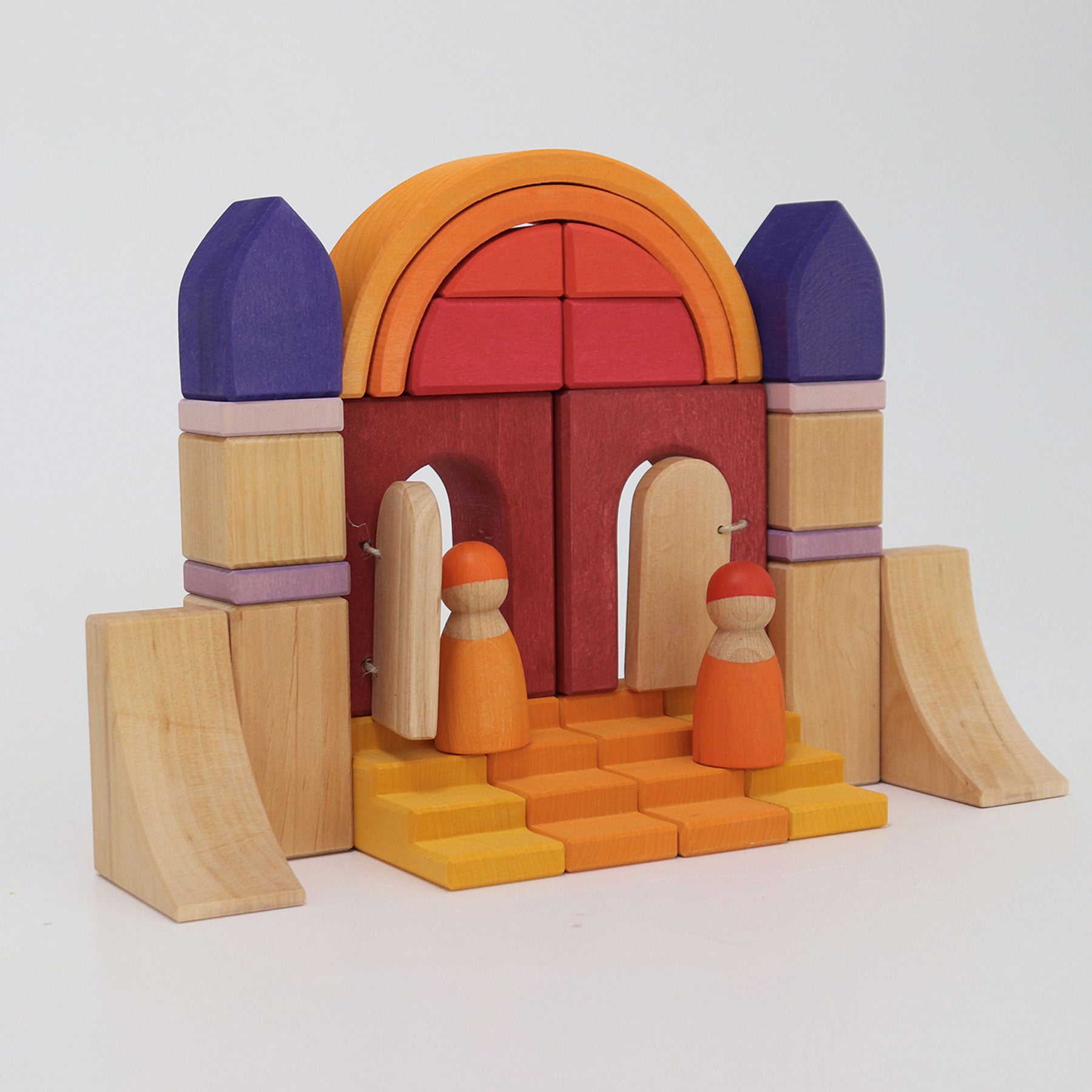 Colorful wooden toy set with arches and figures on a white background