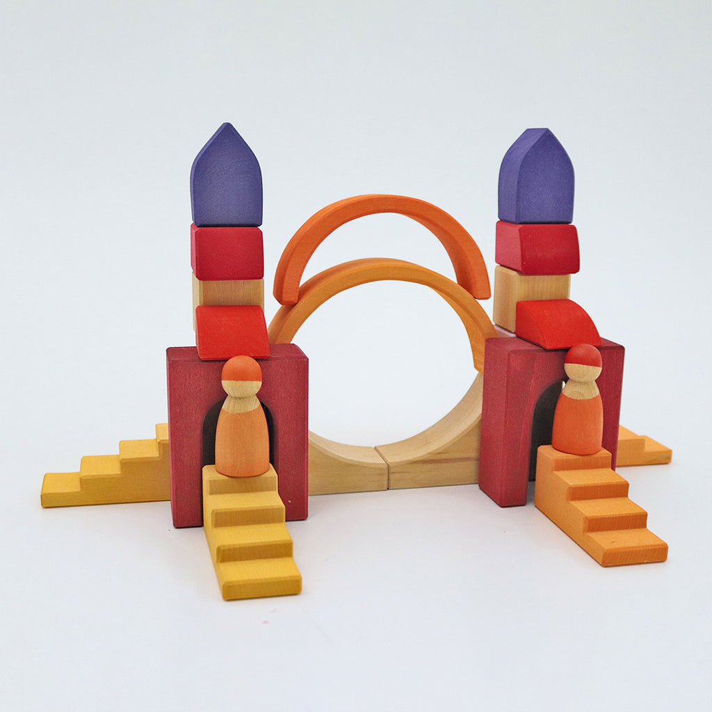 Colorful toy architectural model with arch and steps on a white background
