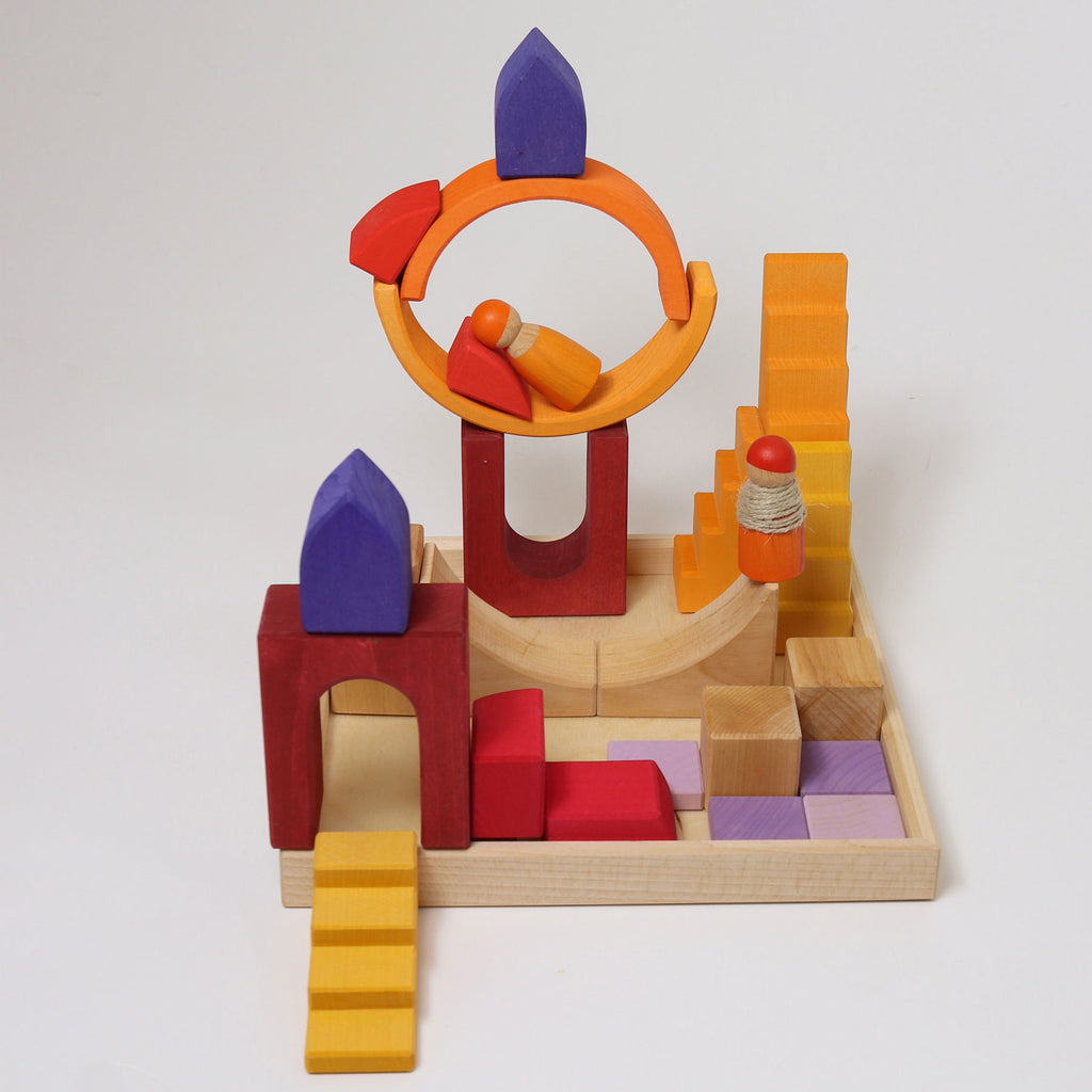 Colorful wooden toy with various shapes and structures on a white background