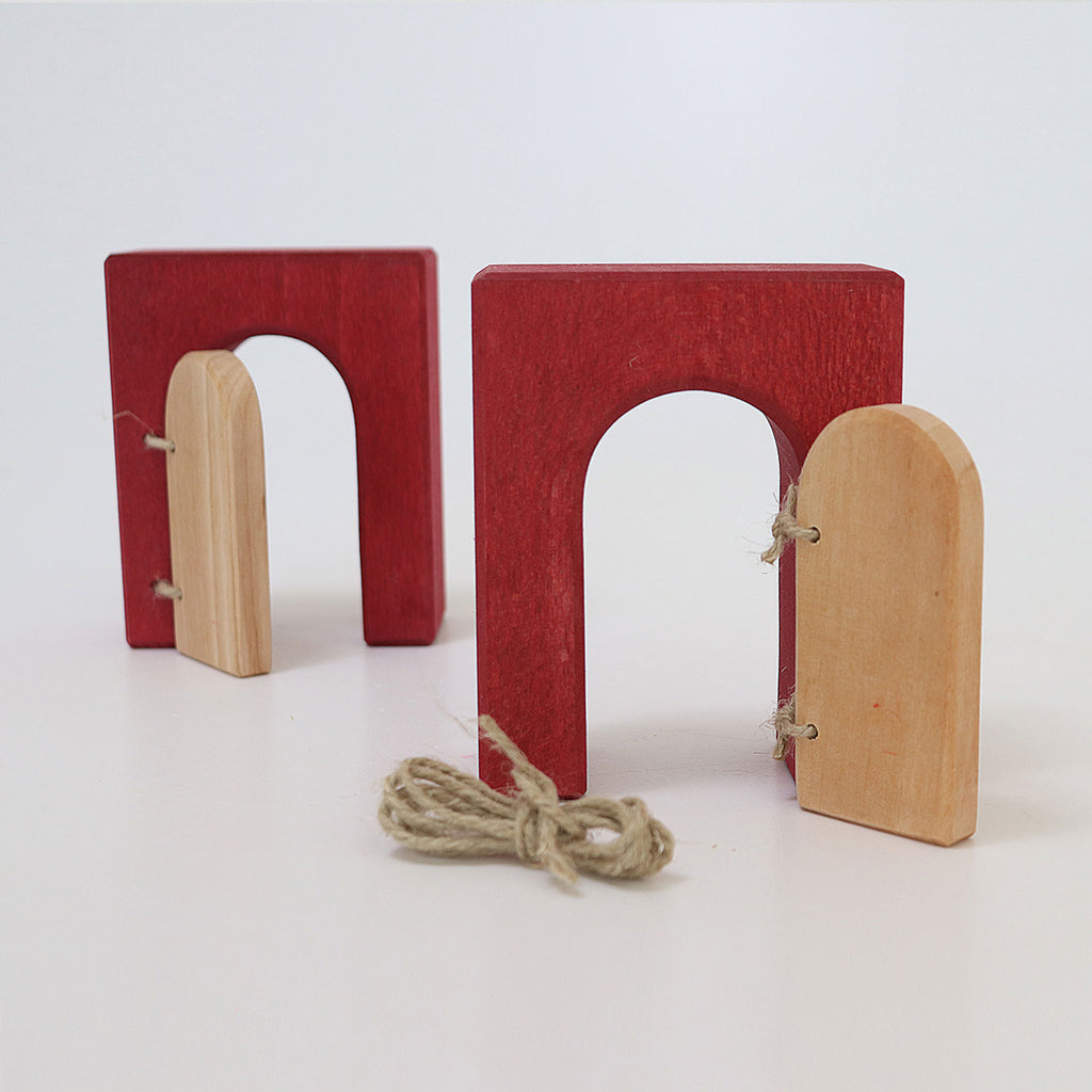 Red and beige wooden puzzle toy on a white background