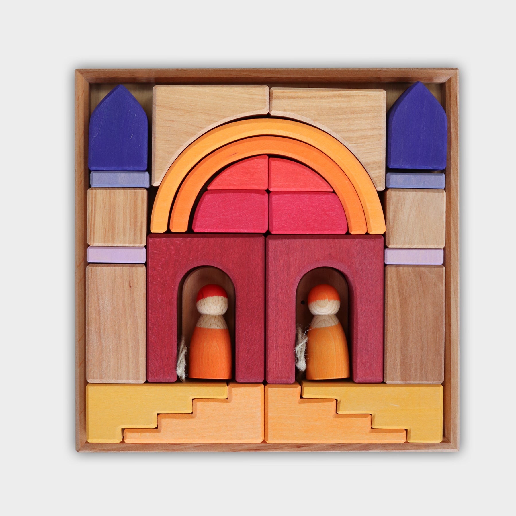 Colorful wooden building blocks set in a box on a white background