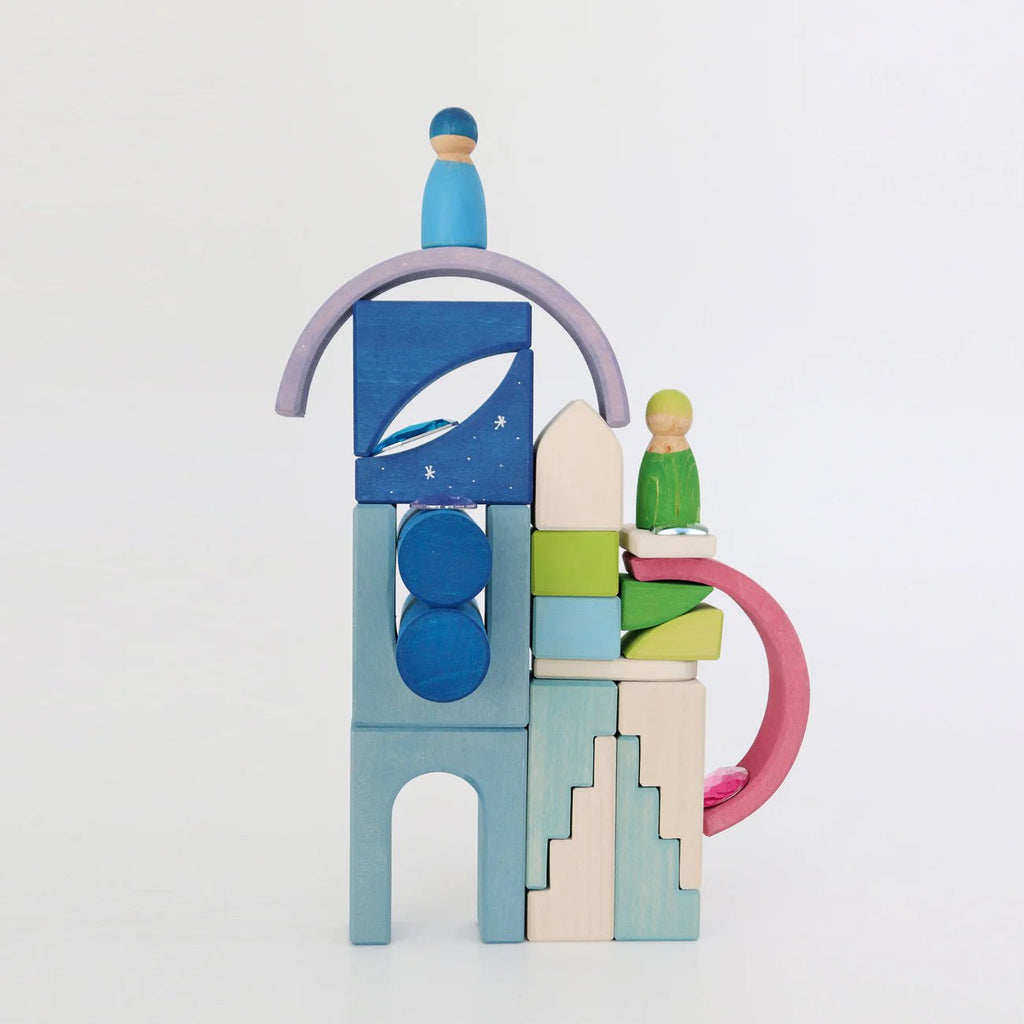 Colorful wooden toy blocks stacked on a white background