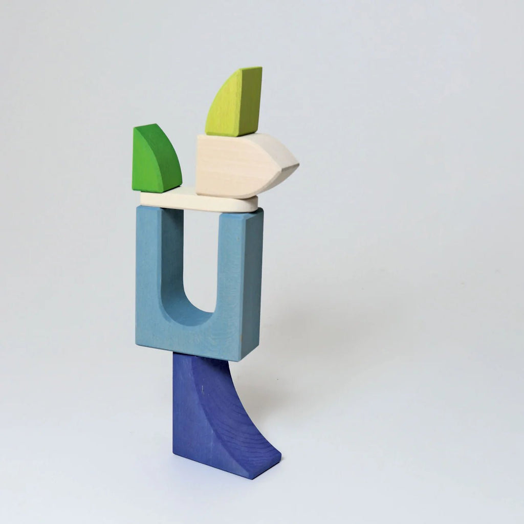 Colorful wooden block sculpture on a white background