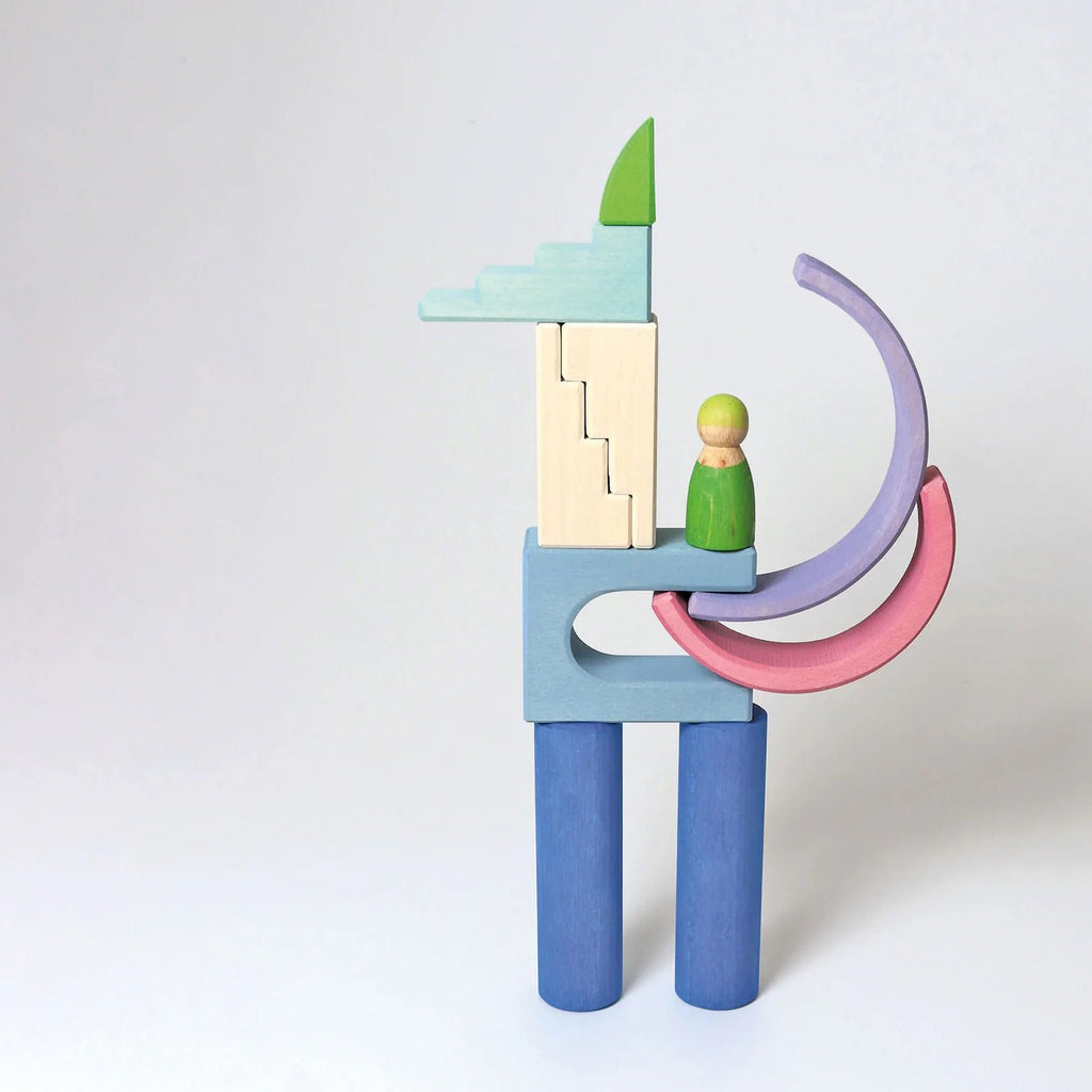 Colorful wooden toy figure with a green peg person on a white background