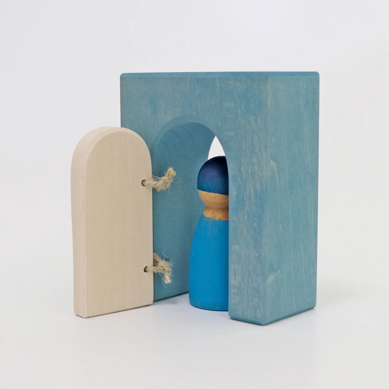 Wooden toy with a blue arch and beige door on a white background