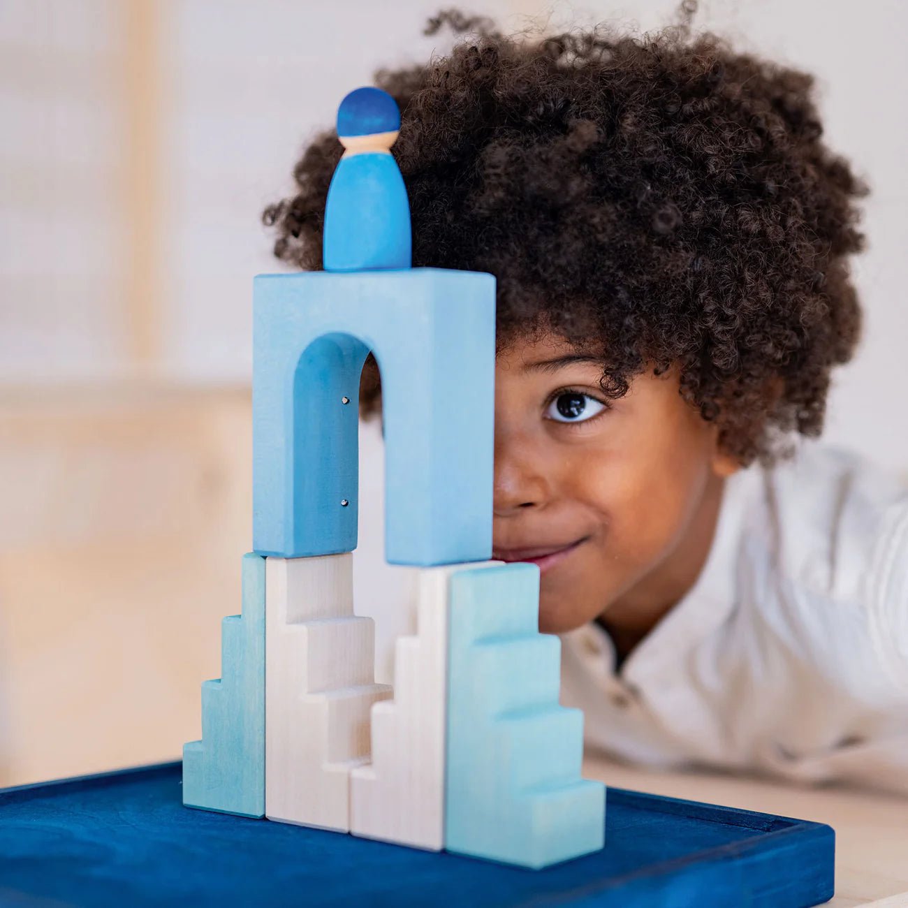 Child playing with blue and white building blocks