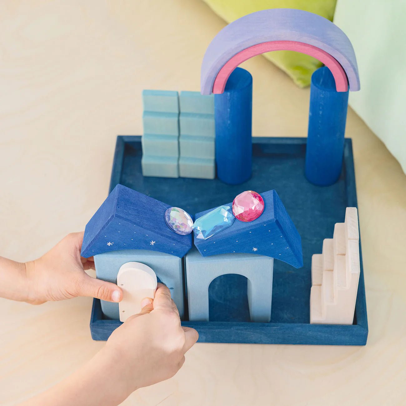Children's toy set with colorful blocks and arches on a beige surface