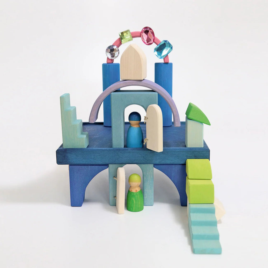 Colorful wooden toy set with arches and peg people on a white background