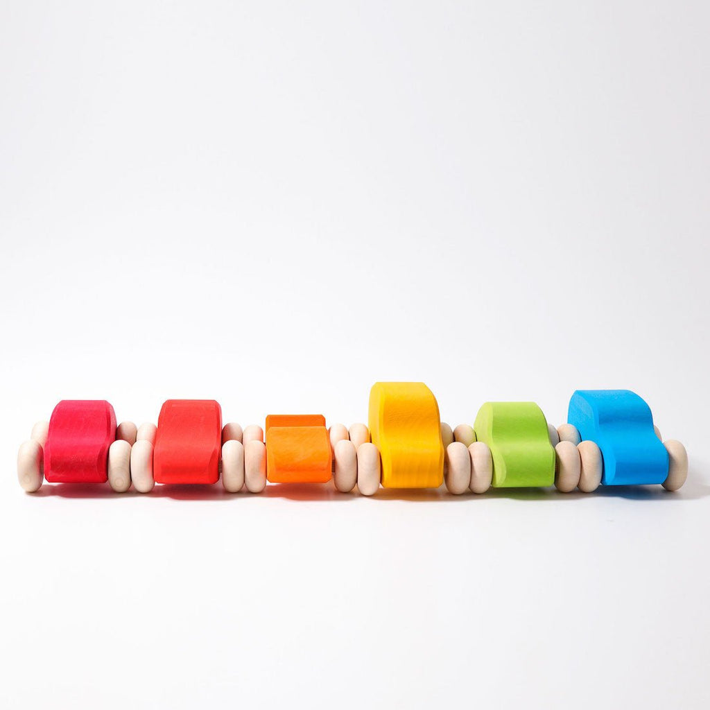 Colorful wooden cars on a white background