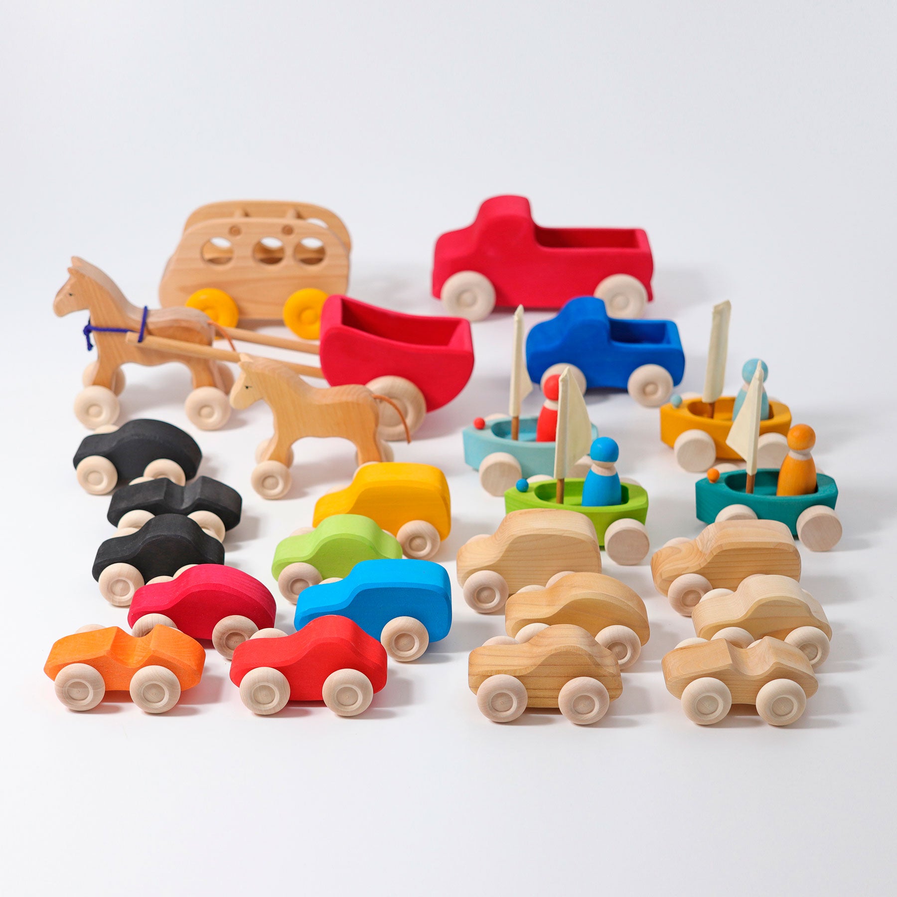 Assorted wooden toy vehicles on a white background