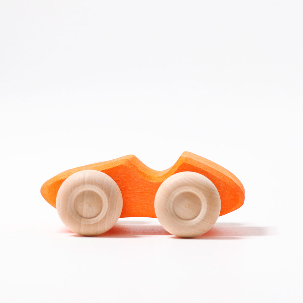 Wooden toy car with orange body and white wheels on a white background