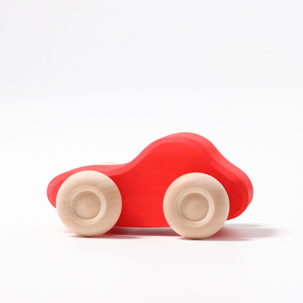 Red toy car with white wheels on a white background