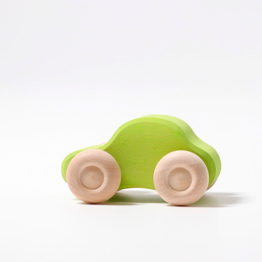 Green wooden toy car on a white background