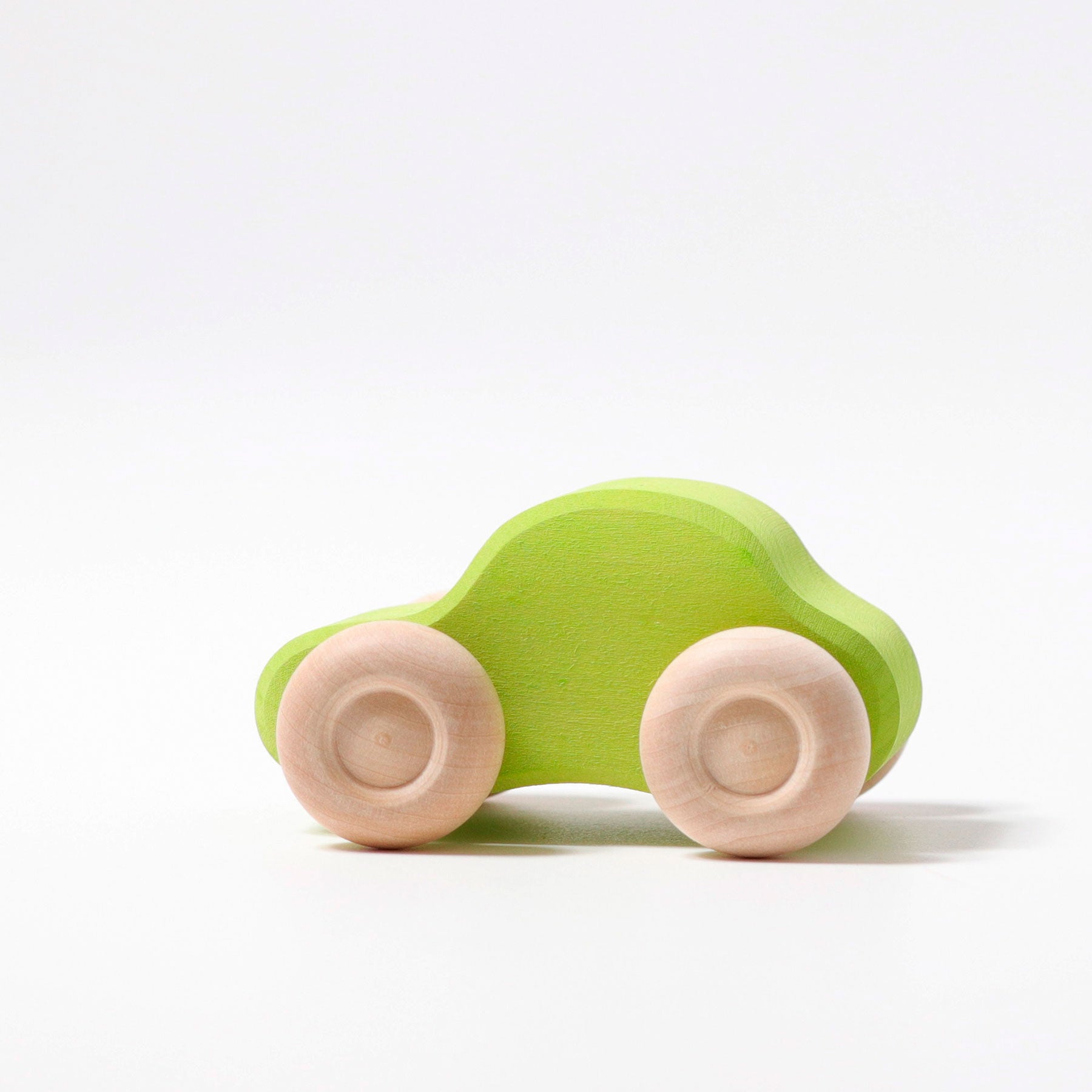 Green wooden toy car on a white background