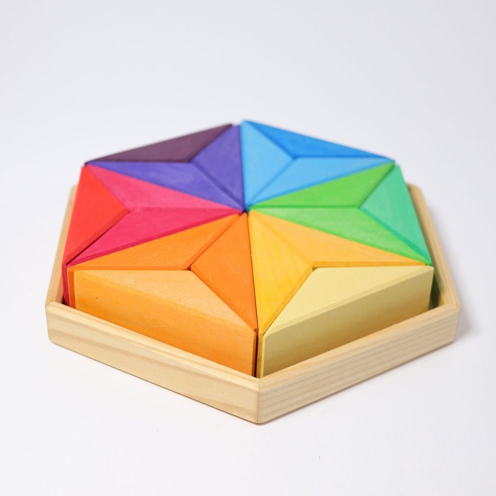 Colorful geometric puzzle in a wooden box on a white background