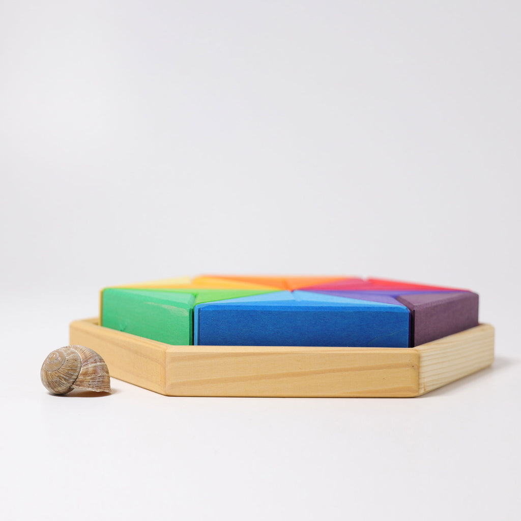 Colorful geometric wooden blocks on a light gray background