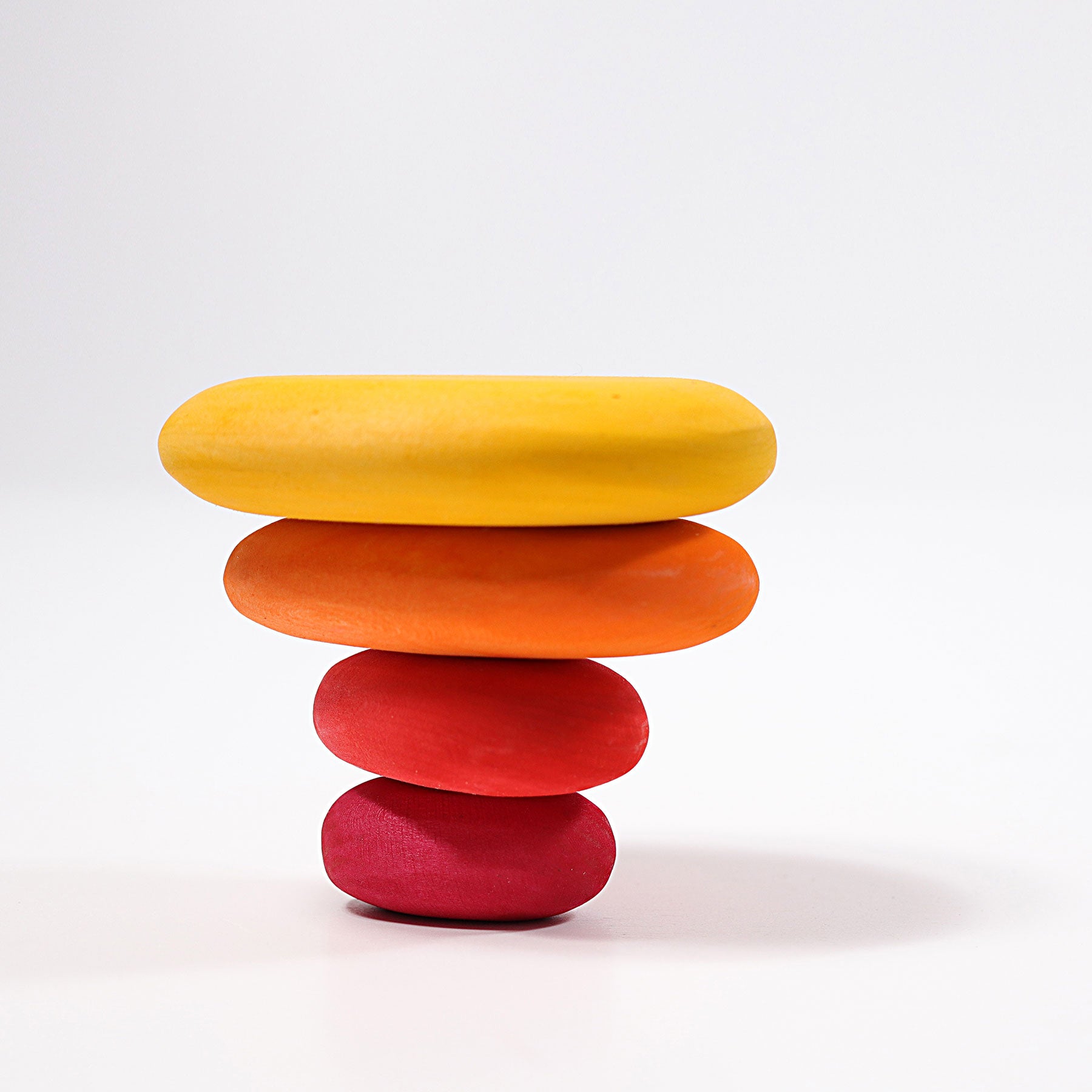 Stack of colorful wooden stones on a white background