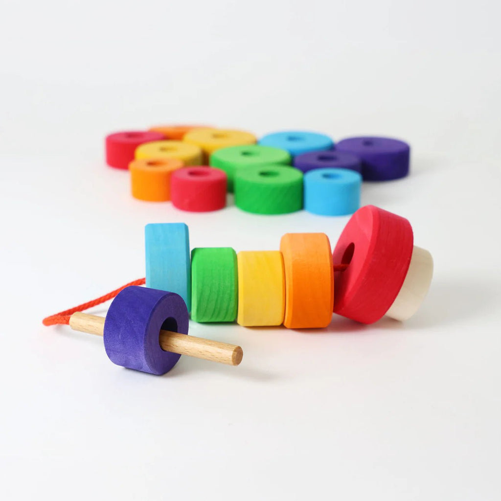 Colorful wooden toy with interlocking rings on a white background